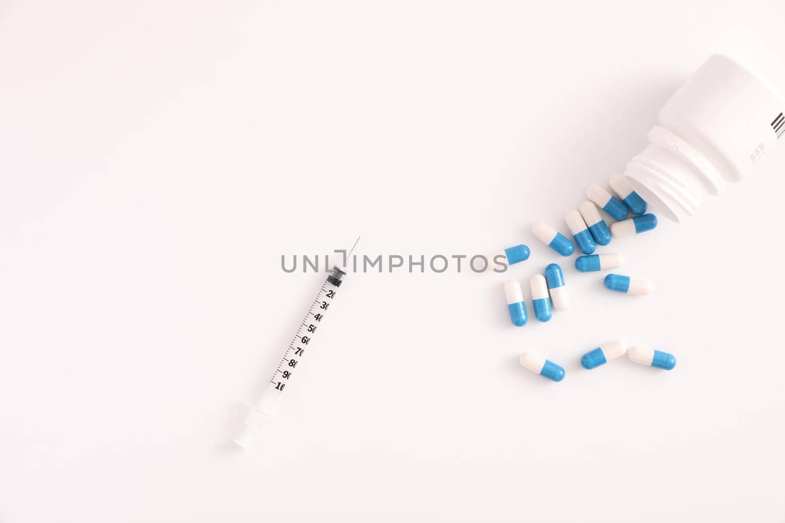 Syringe and pill isolated in white background by piyato