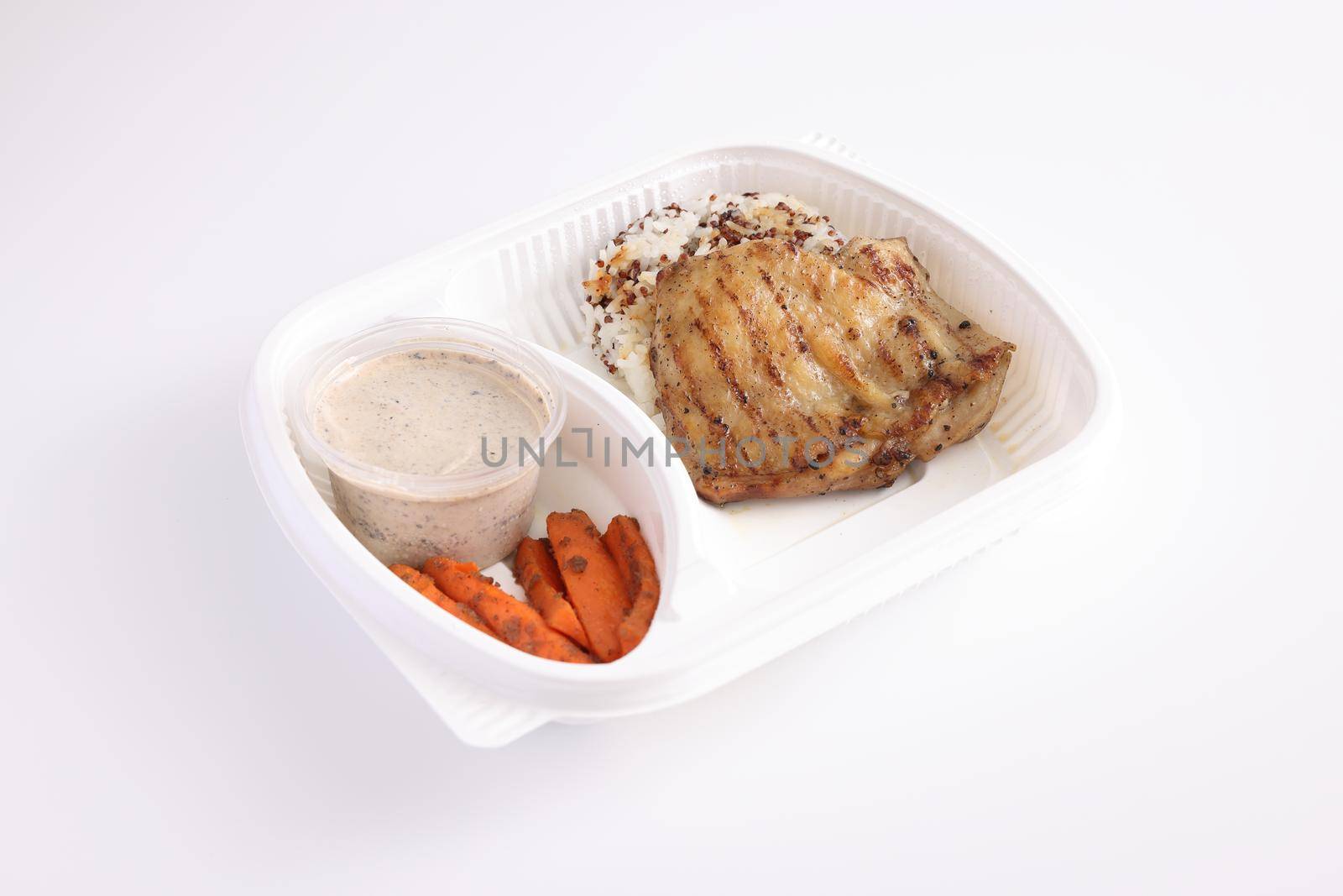 Grilled chicken with rice with delivery take home package isolated in white background by piyato