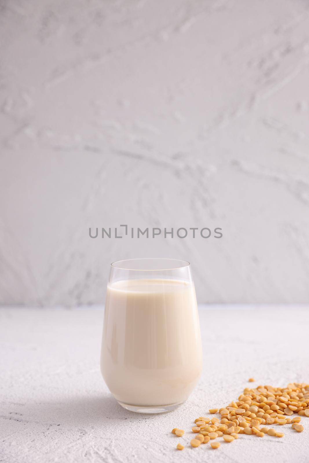 Soy milk in glass and soy bean isolated in white background by piyato