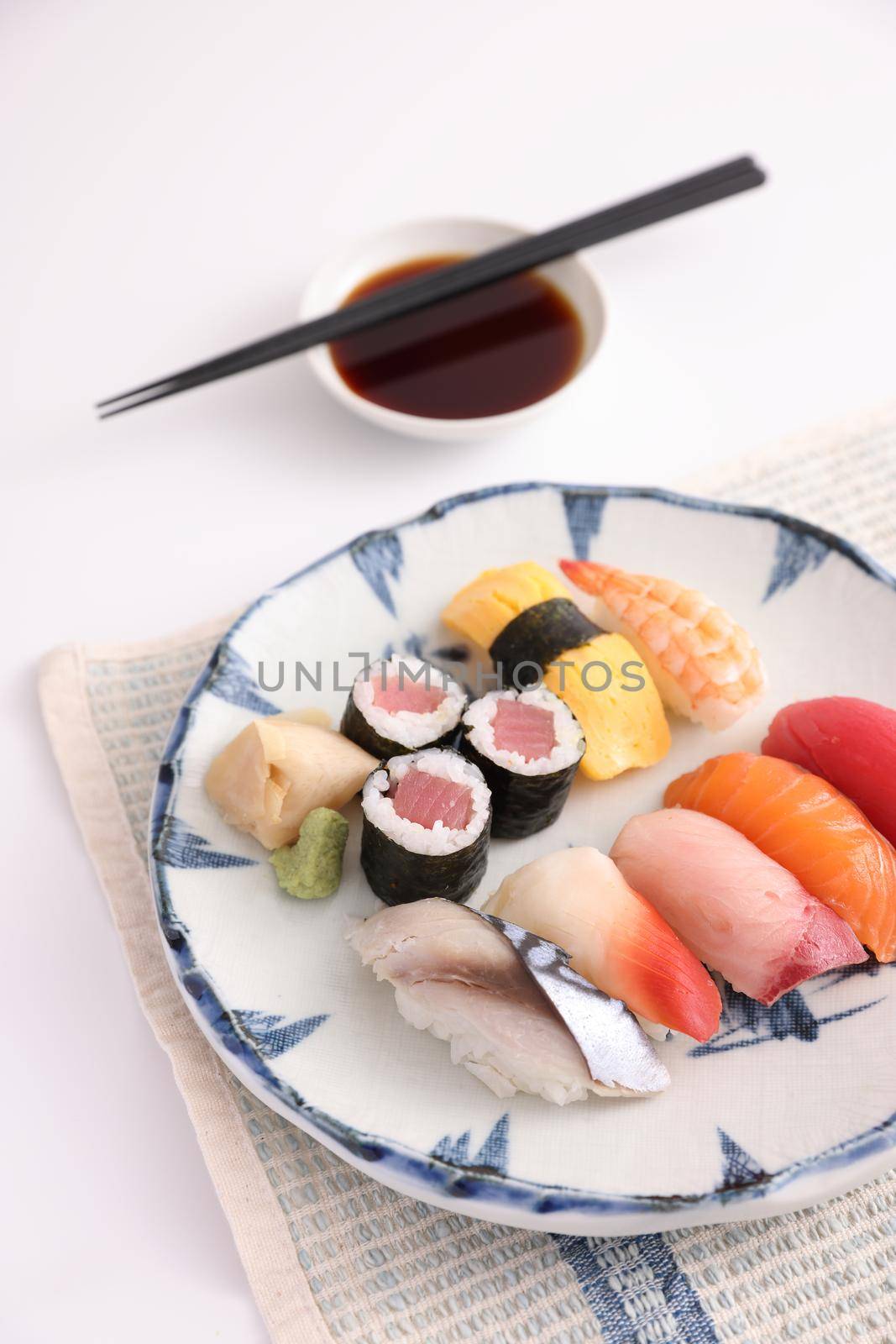 Sushi Set nigiri and sushi rolls with soy sauce and chopsticks Japanese food isolated in white background by piyato