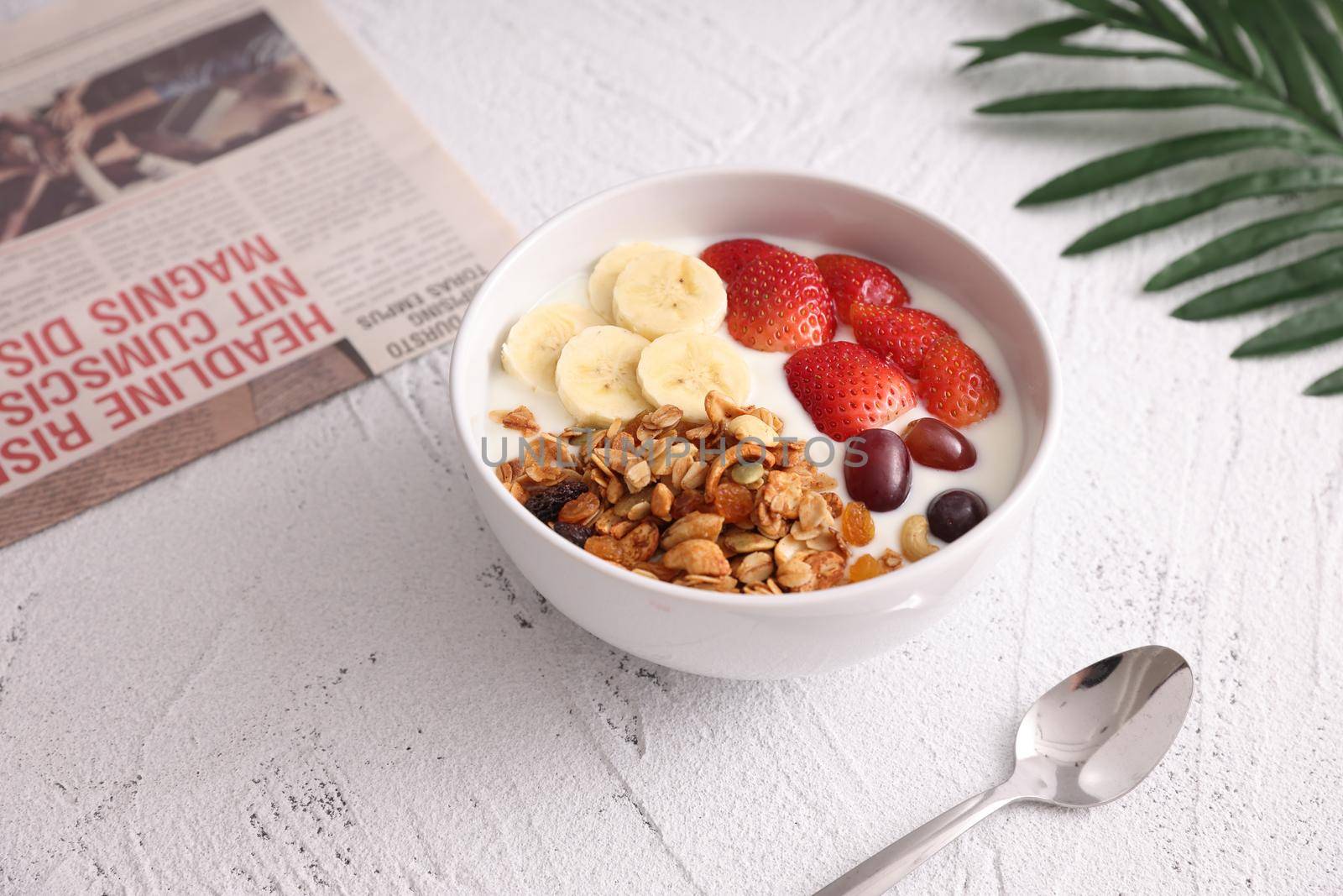 bowl of granola cereal with yogurt and berries isolated on white background by piyato