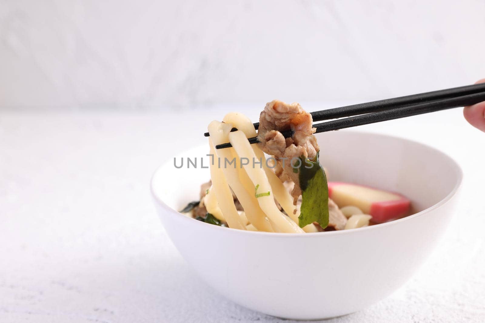 Udon noodles with pork isolated in white background by piyato