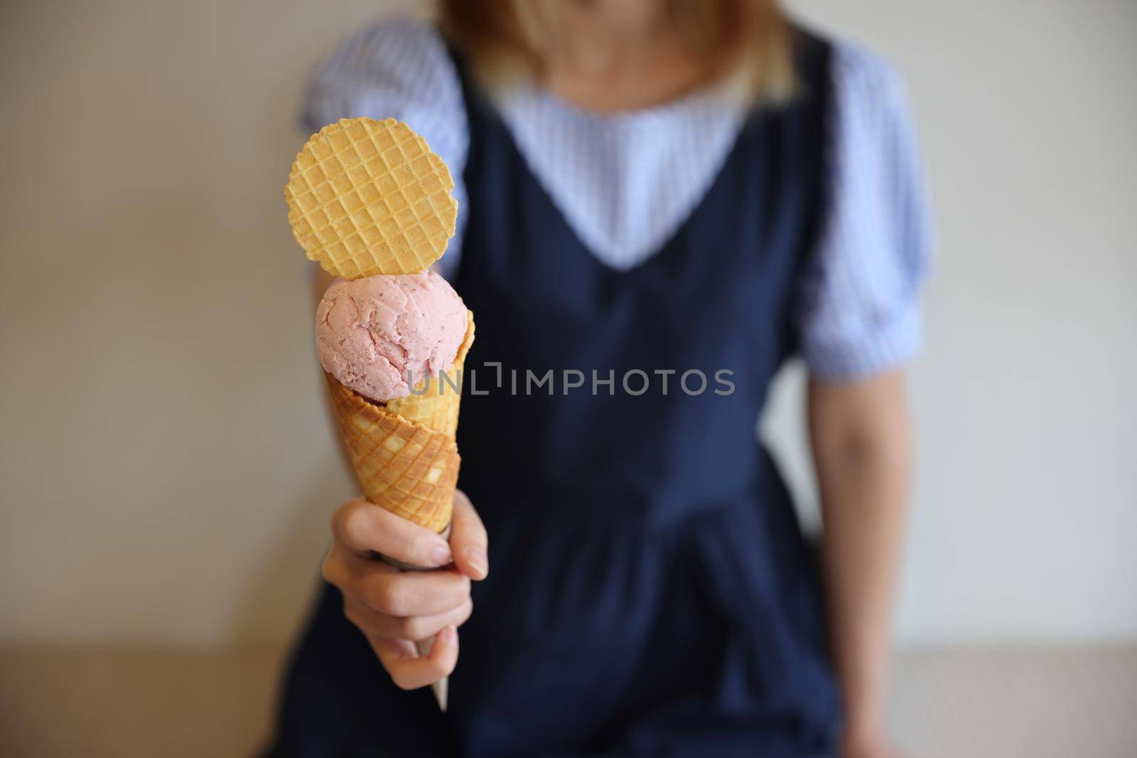 Young woman hand with holding ice cream cone