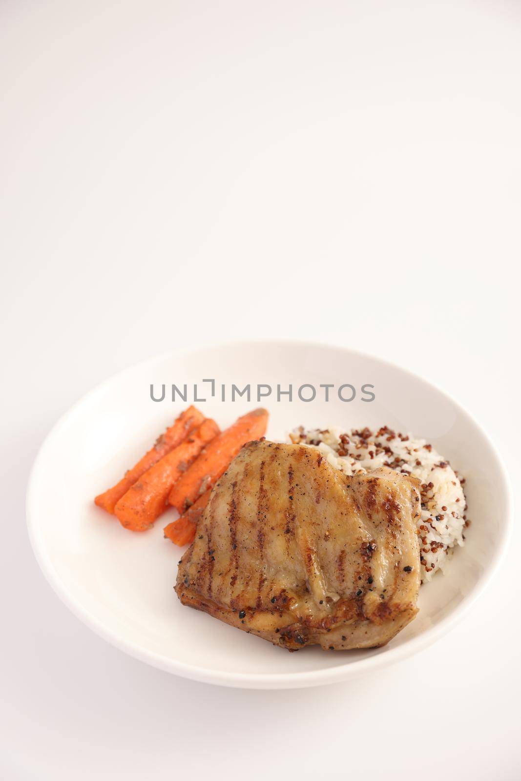 Grilled chicken with rice isolated in white background by piyato