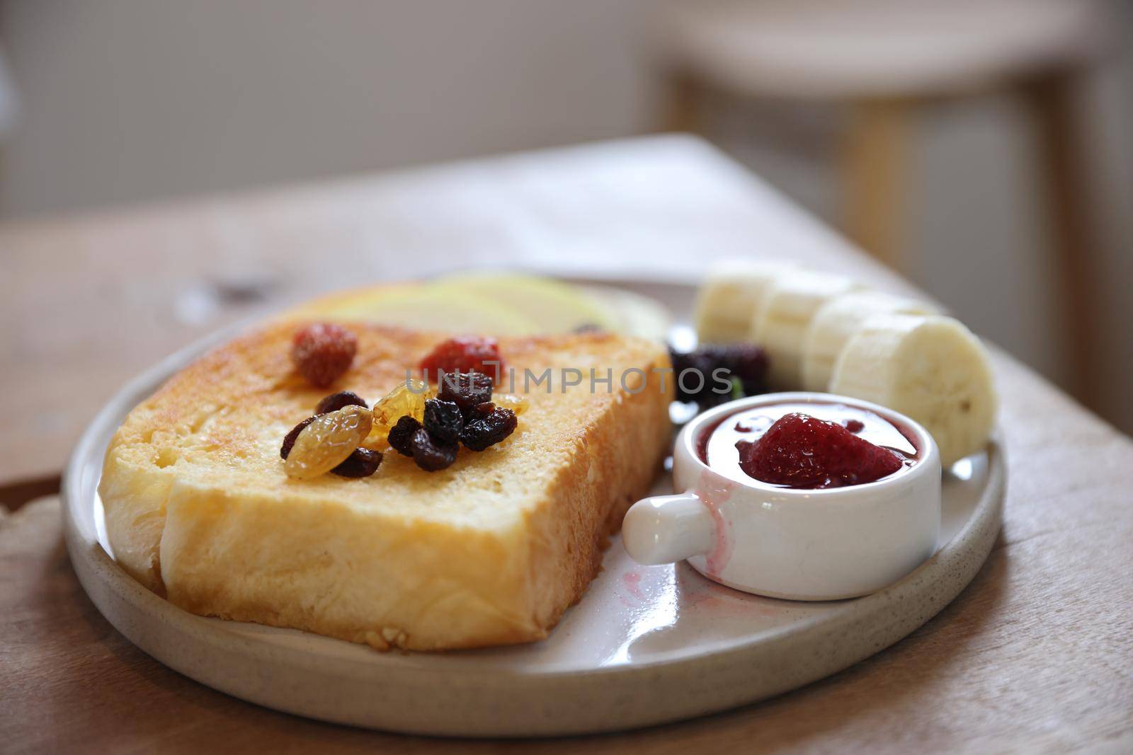 Toast breakfast with dried berry and jam on wood background