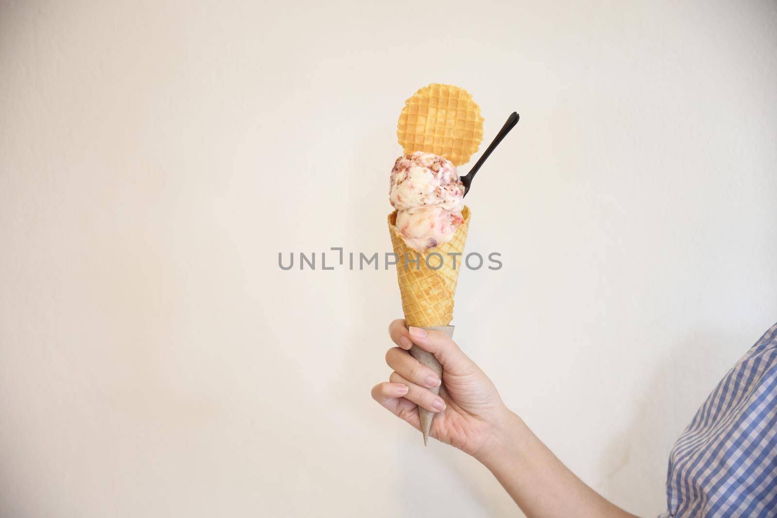 Young woman hand with holding ice cream cone by piyato