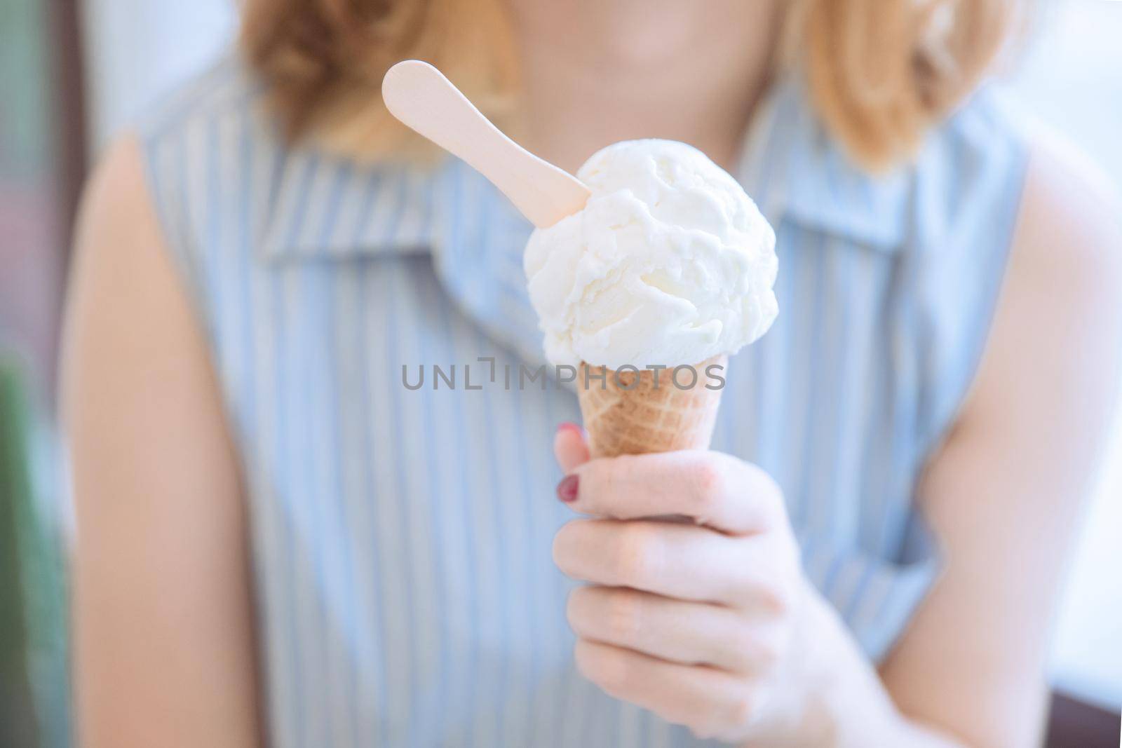 Young woman hand with ice cream at coffee shop modern life style by piyato