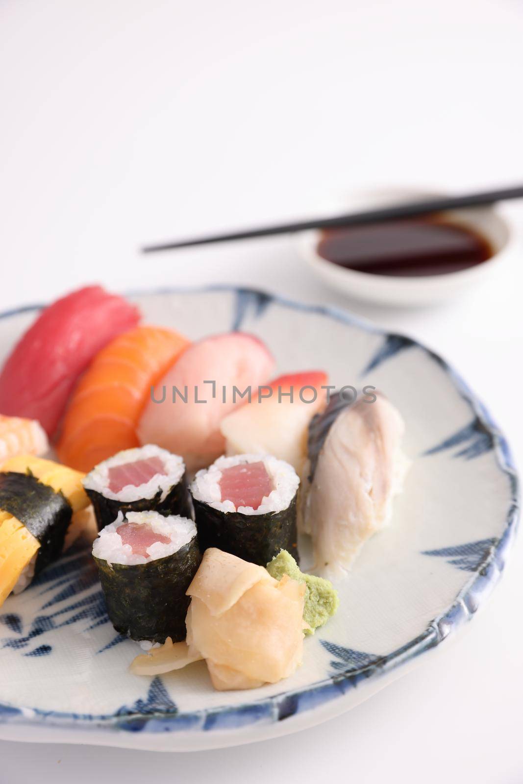 Sushi Set nigiri and sushi rolls with soy sauce and chopsticks Japanese food isolated in white background