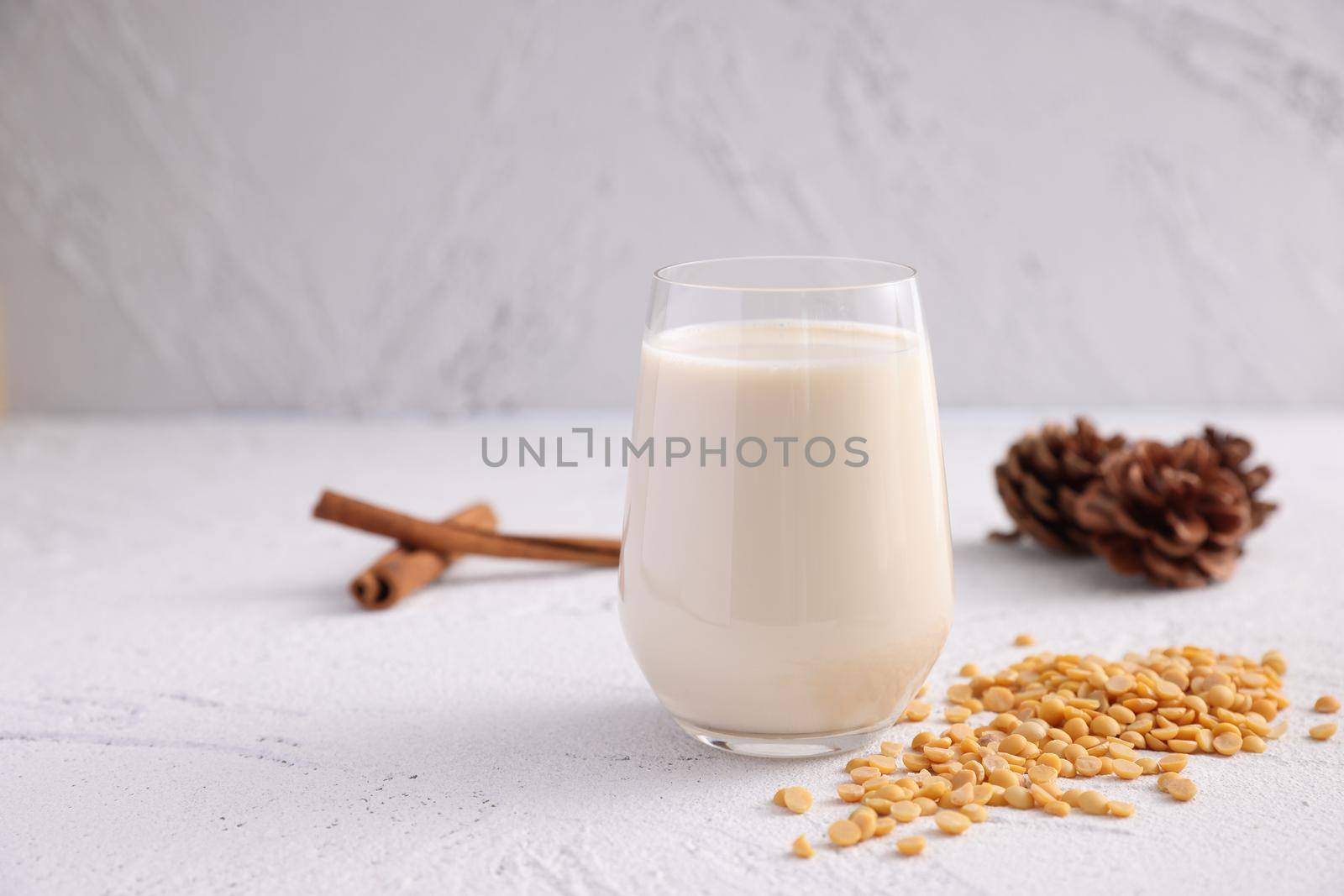 Soy milk in glass and soy bean isolated in white background by piyato