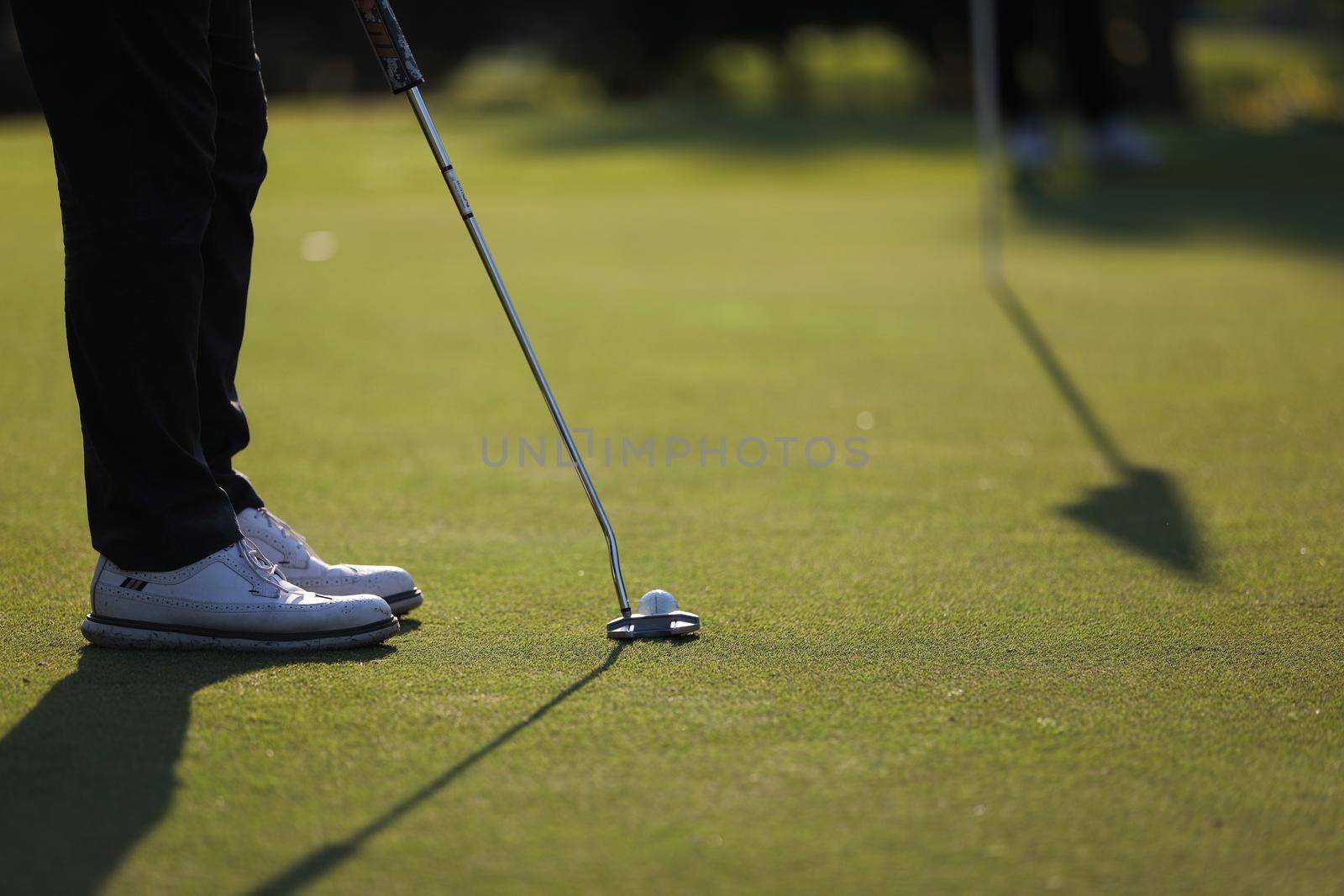 Young male golfer player on golf course by piyato