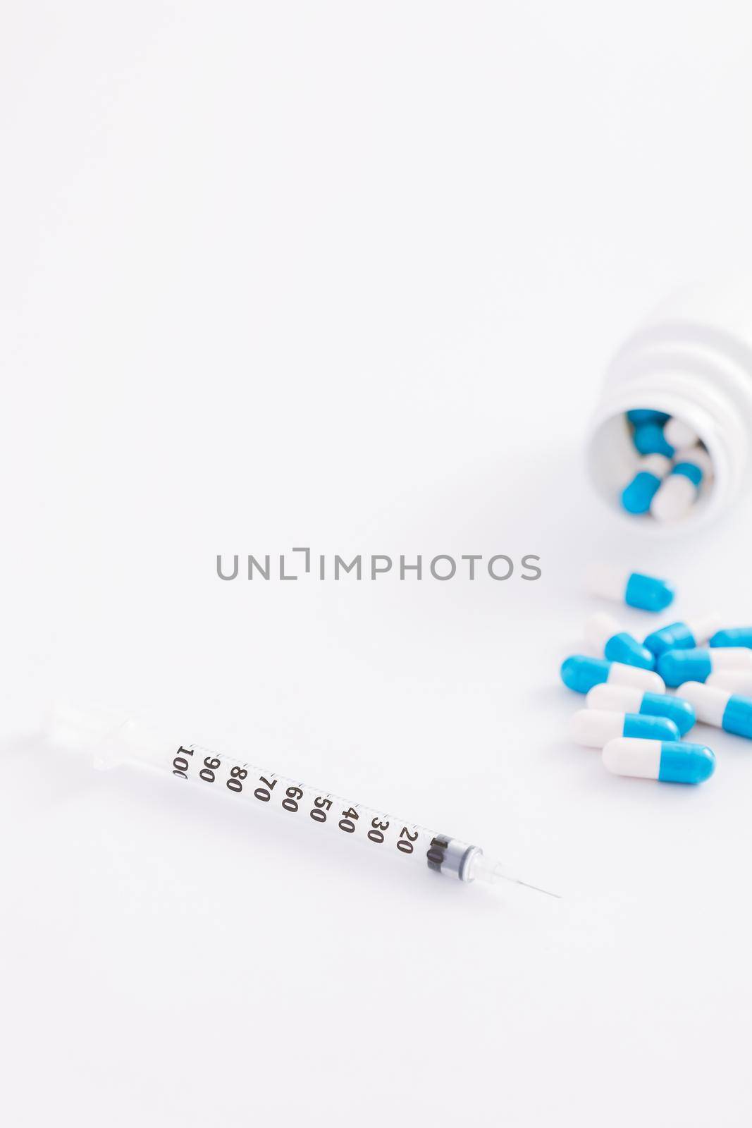 Syringe and pill isolated in white background by piyato