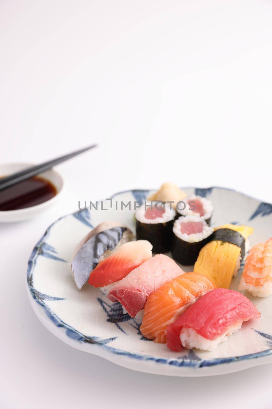 Sushi Set nigiri and sushi rolls with soy sauce and chopsticks Japanese food isolated in white background by piyato