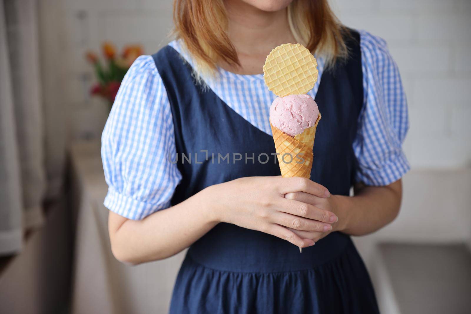 Young woman hand with holding ice cream cone