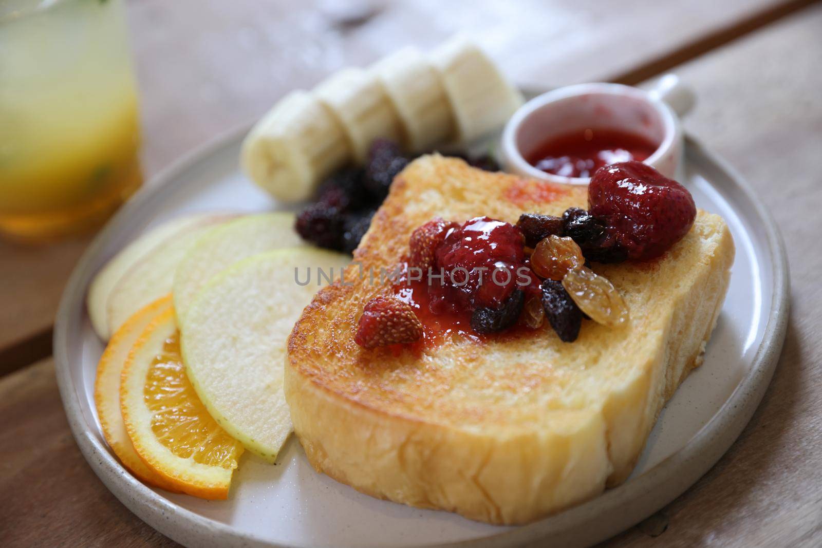 Toast breakfast with dried berry and jam on wood background