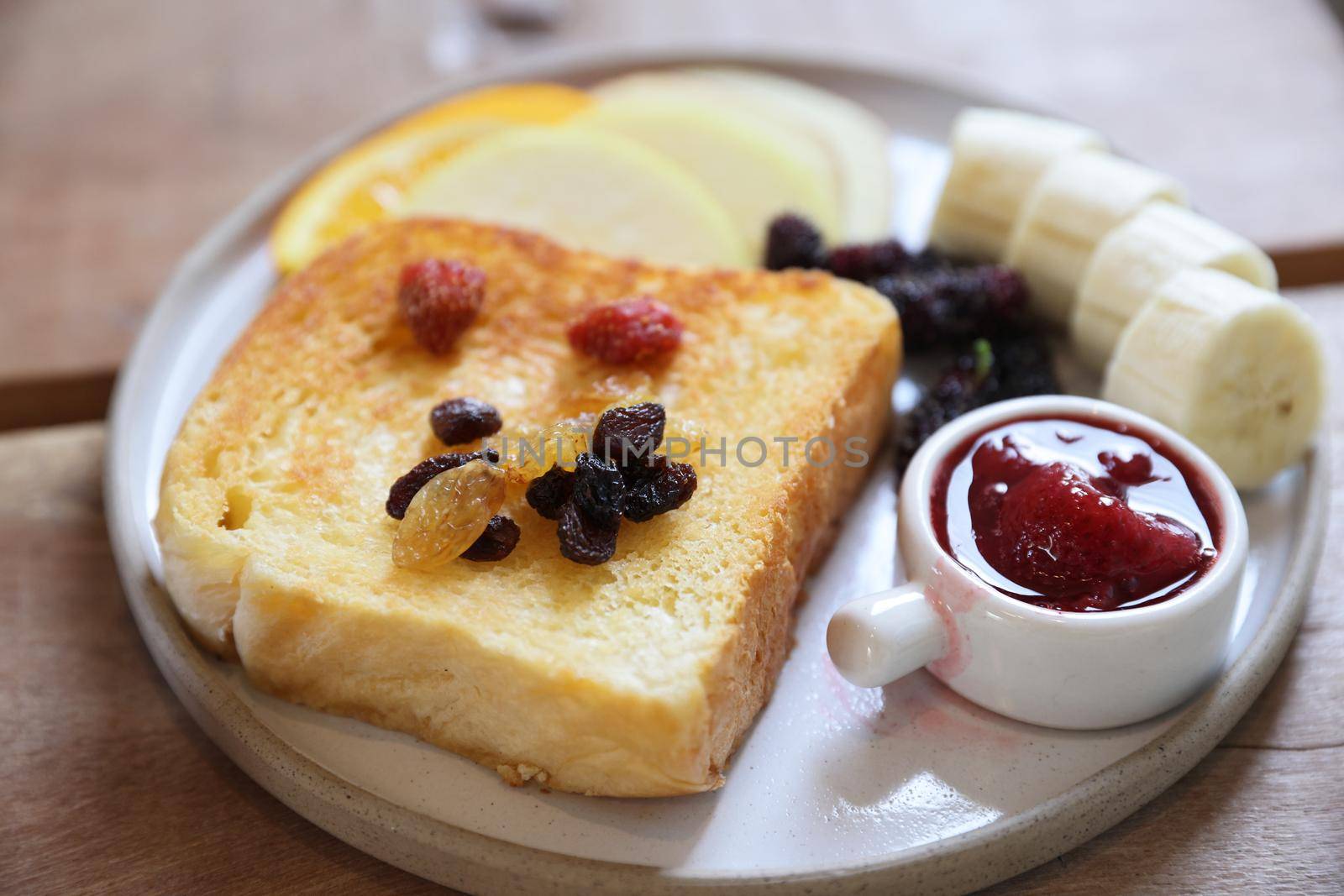 Toast breakfast with dried berry and jam on wood background by piyato