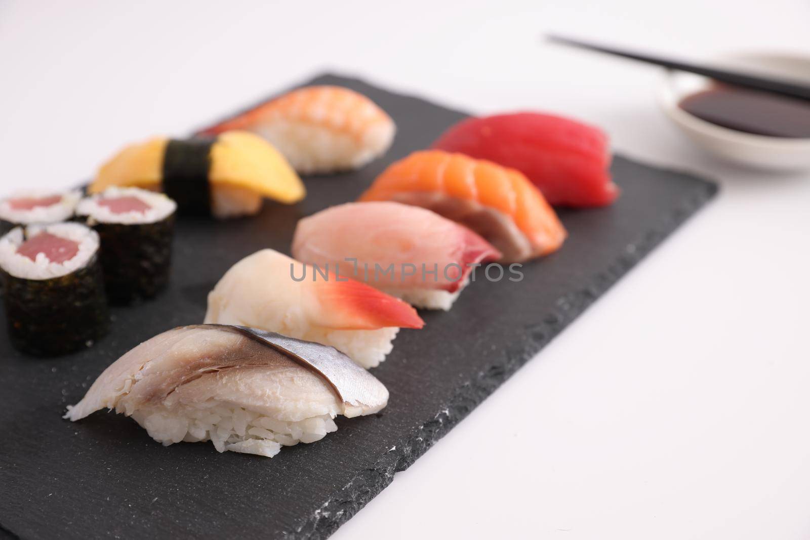 Sushi Set nigiri and sushi rolls with soy sauce and chopsticks Japanese food isolated in white background by piyato