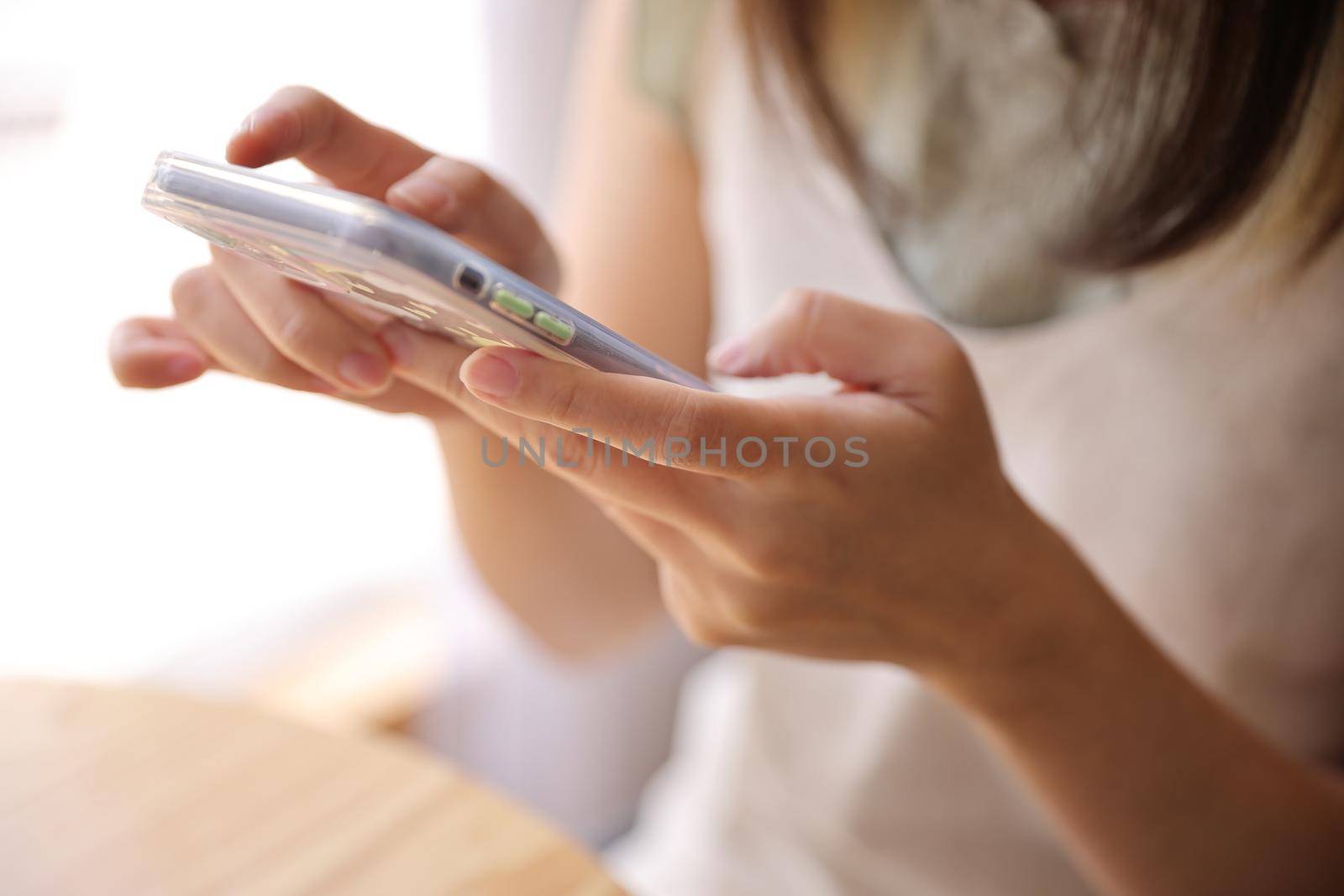 Woman hand using a smartphone for Stock exchange trading online in the coffee shop, business concept by piyato