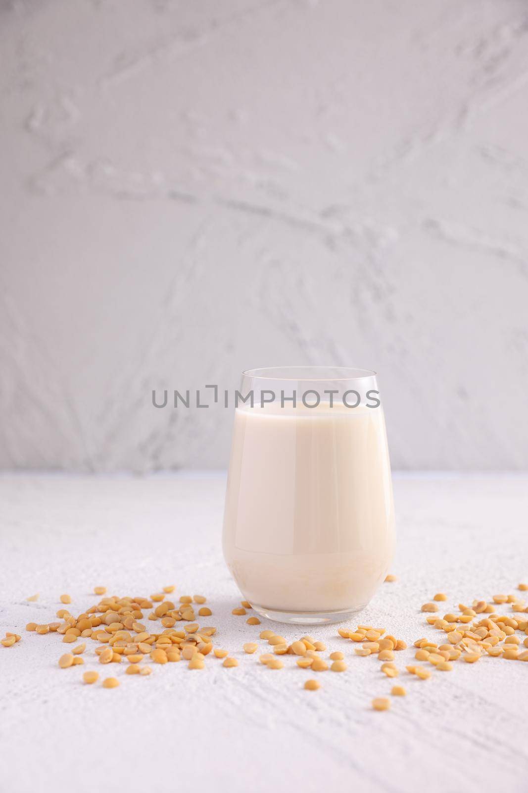 Soy milk in glass and soy bean isolated in white background by piyato