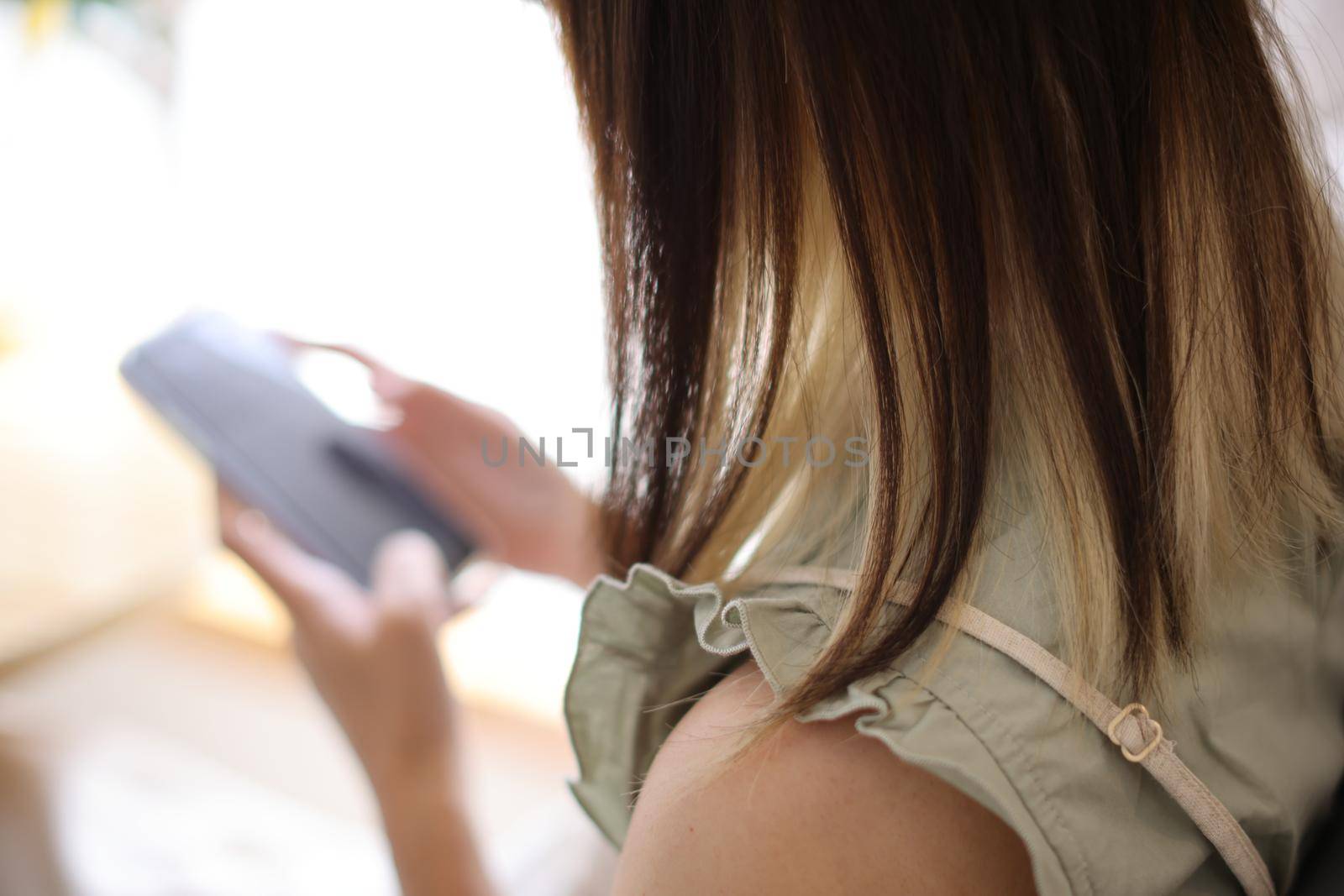 Woman hand using a smartphone for Stock exchange trading online in the coffee shop, business concept by piyato