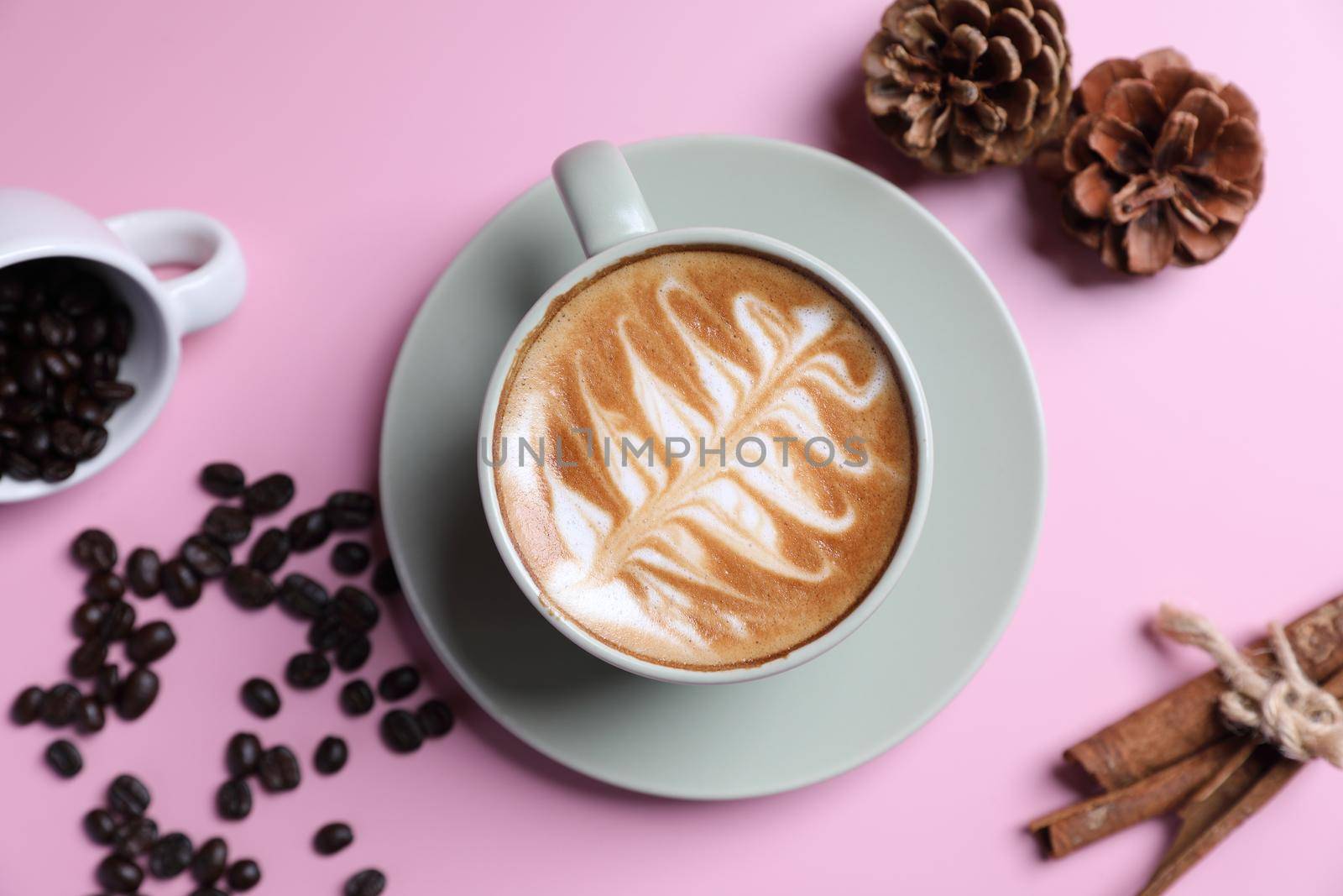 hot cappuccino with latte art isolated in pink background by piyato