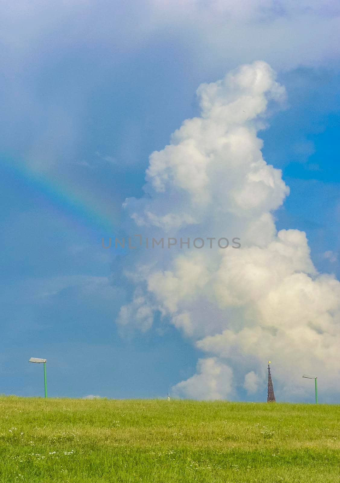 Beautiful rainbow and clouds on the horizon in Bremerhaven Germany. by Arkadij