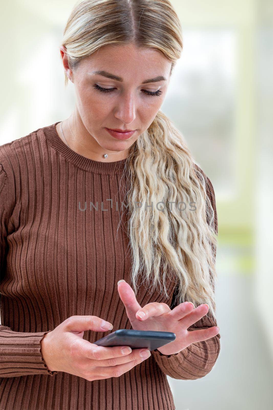 Young woman writing a text message