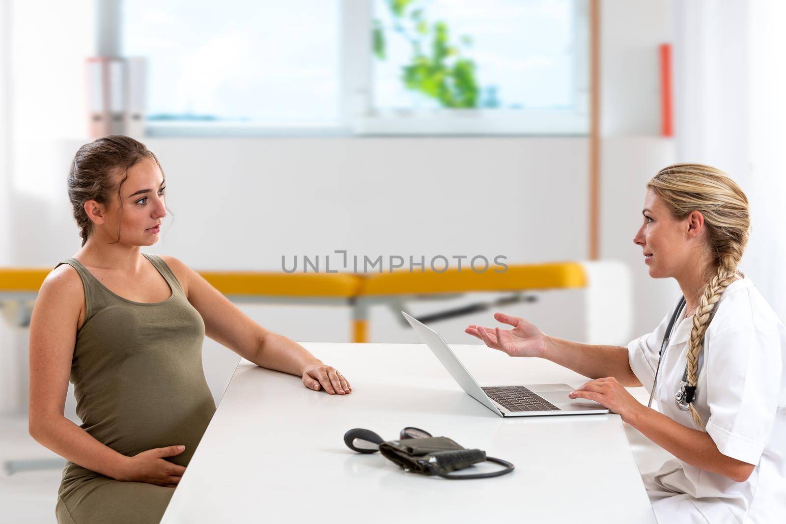 Woman 7 months pregnant in consultation by JPC-PROD