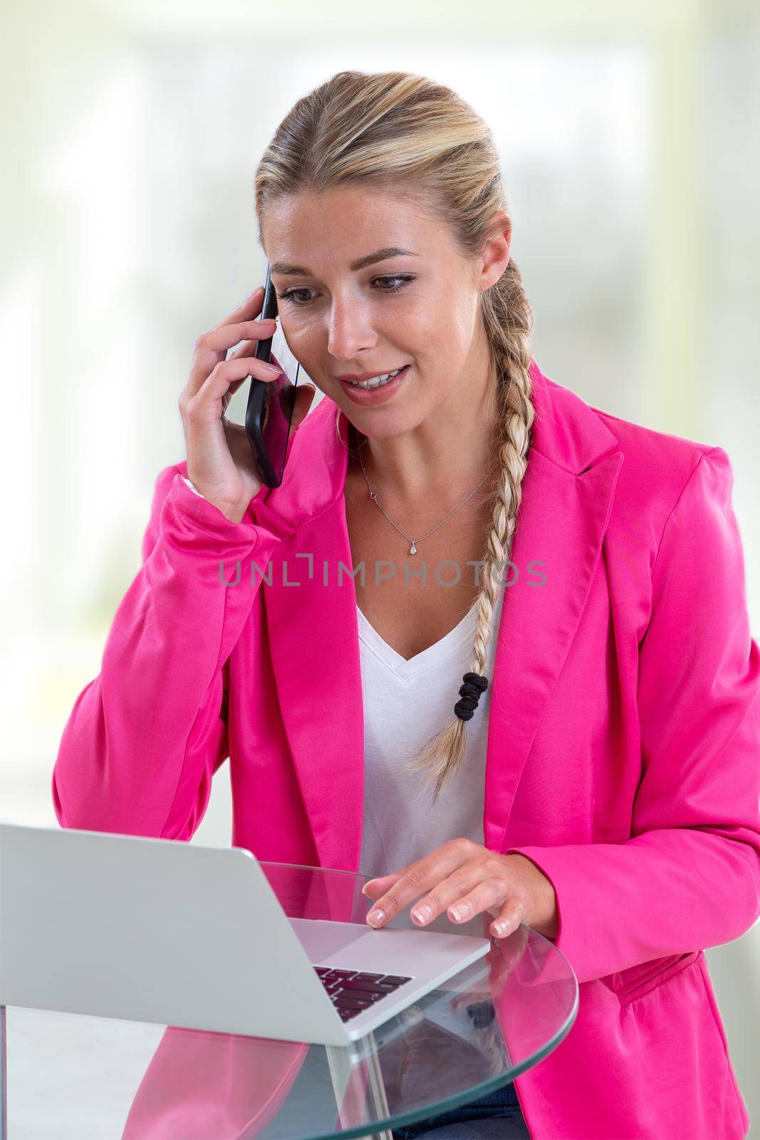 Portrait of a young woman in a telephone relationship in a company. by JPC-PROD