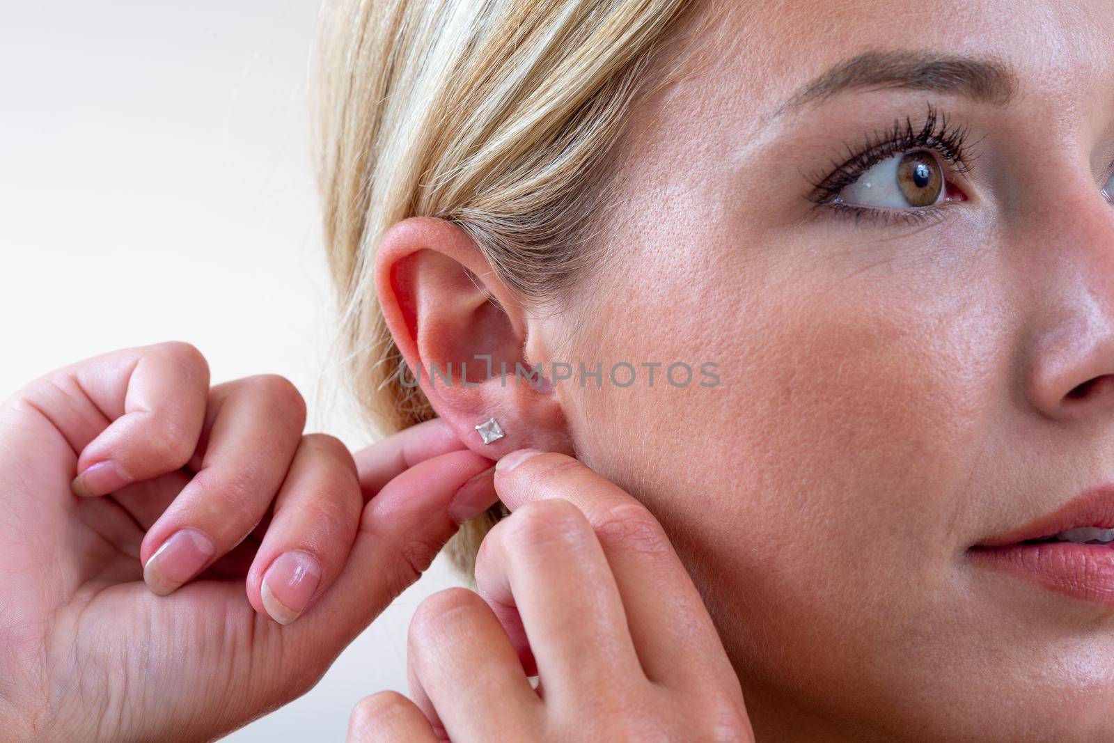 pretty youngwoman hanging an earring