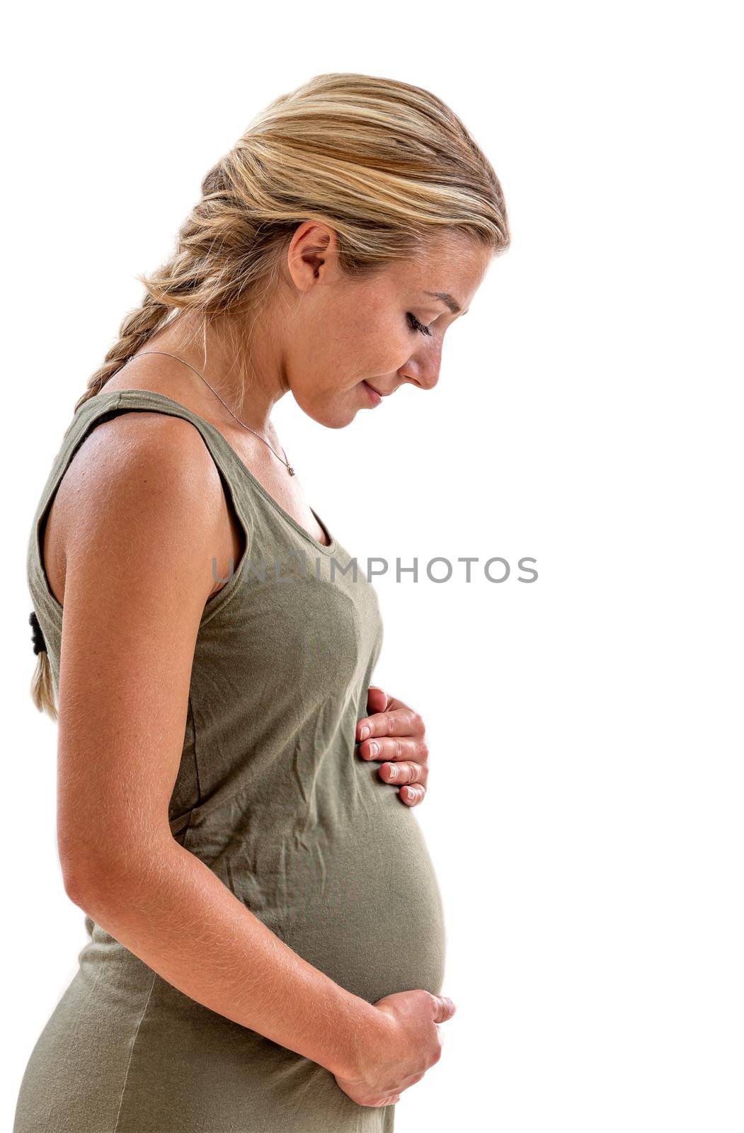 Pregnant woman in profile looking at her belly on a cropped white background. by JPC-PROD