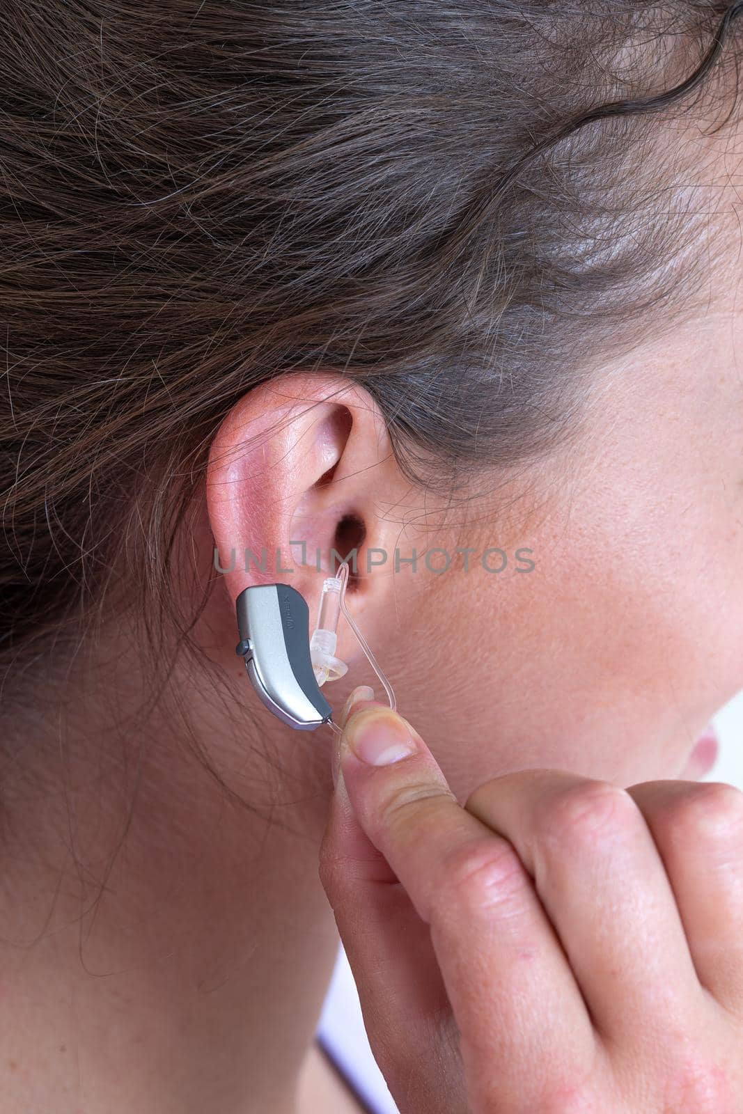 Close-up of the installation of a hearing aid