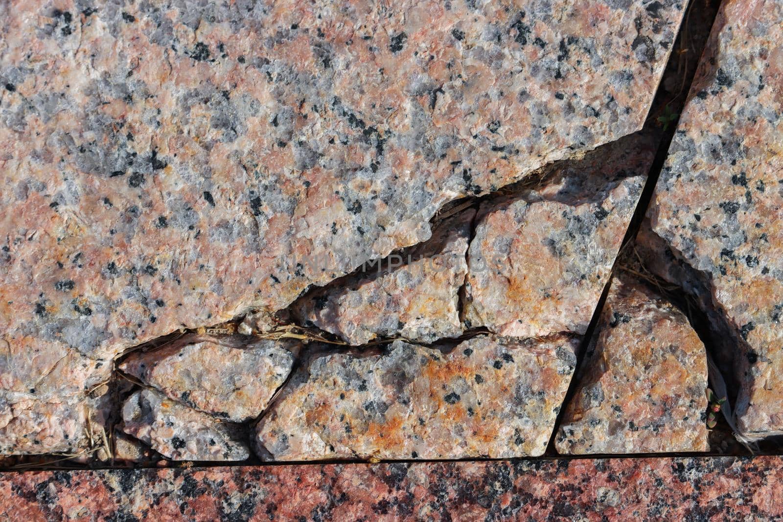 The surface of granite stone with cracks. by gelog67