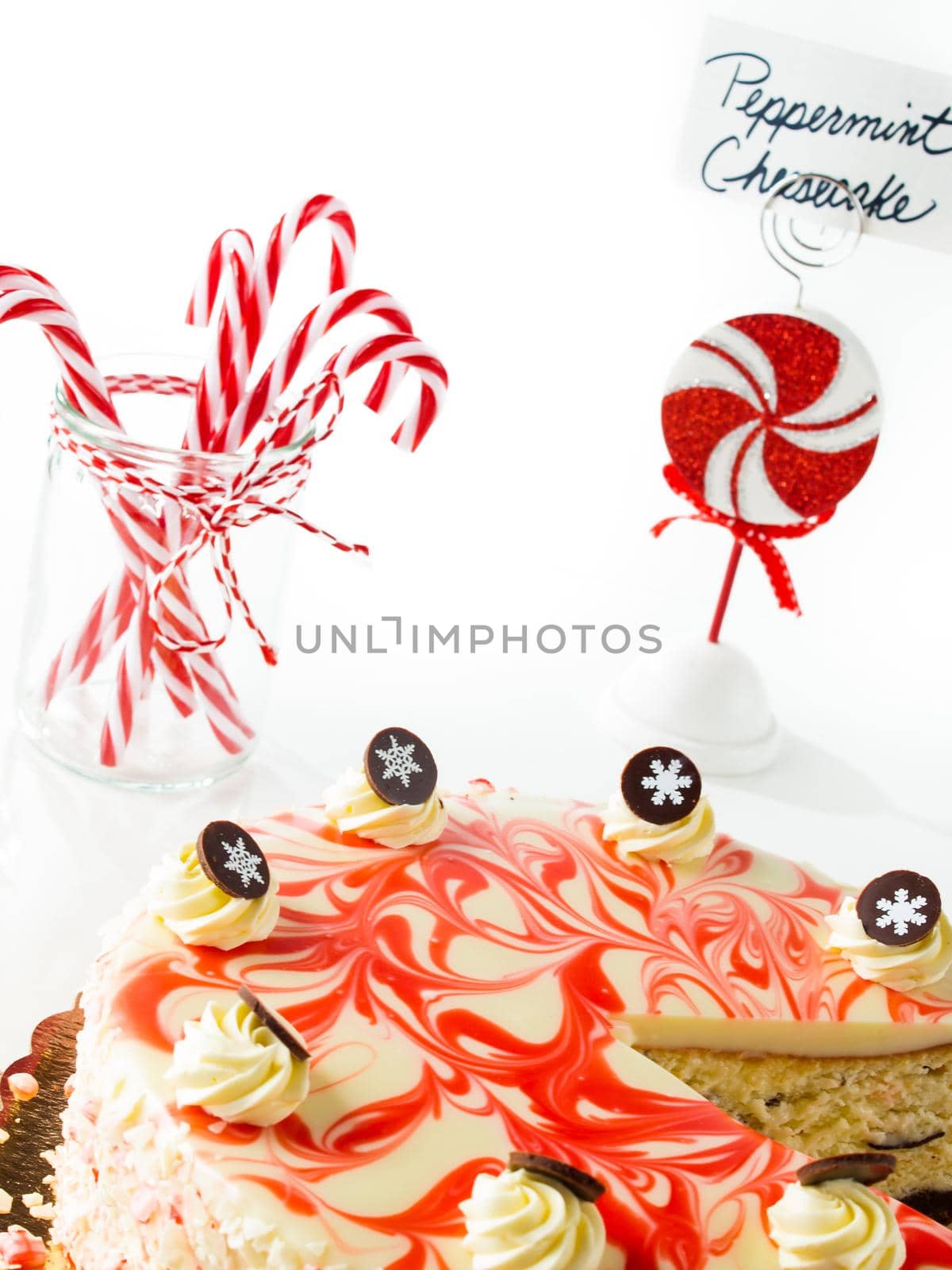 Traditional Christmas White Chocolate Peppermint Cheesecake on white background.