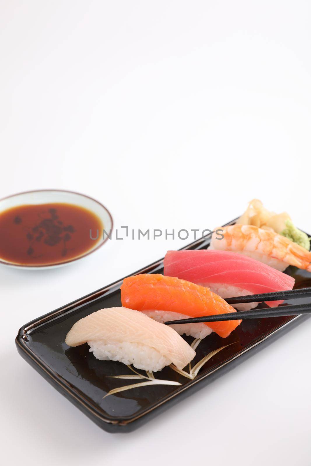 Sushi set , Japanese food sushi salmon tuna shrimp  and sea bass with chopsticks isolated in white background by piyato
