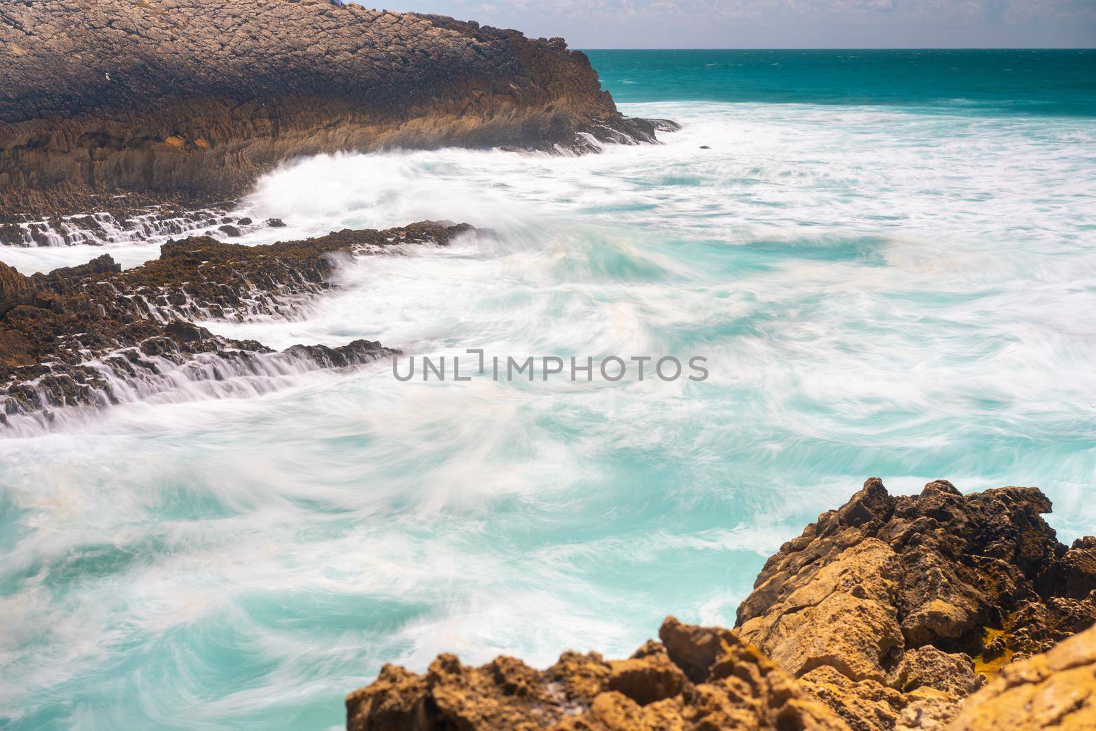 Atlantic ocean. Stormy summer day Big sea wave on rocky beach. Beaty in nature. Dramatic sea view. Long exposure