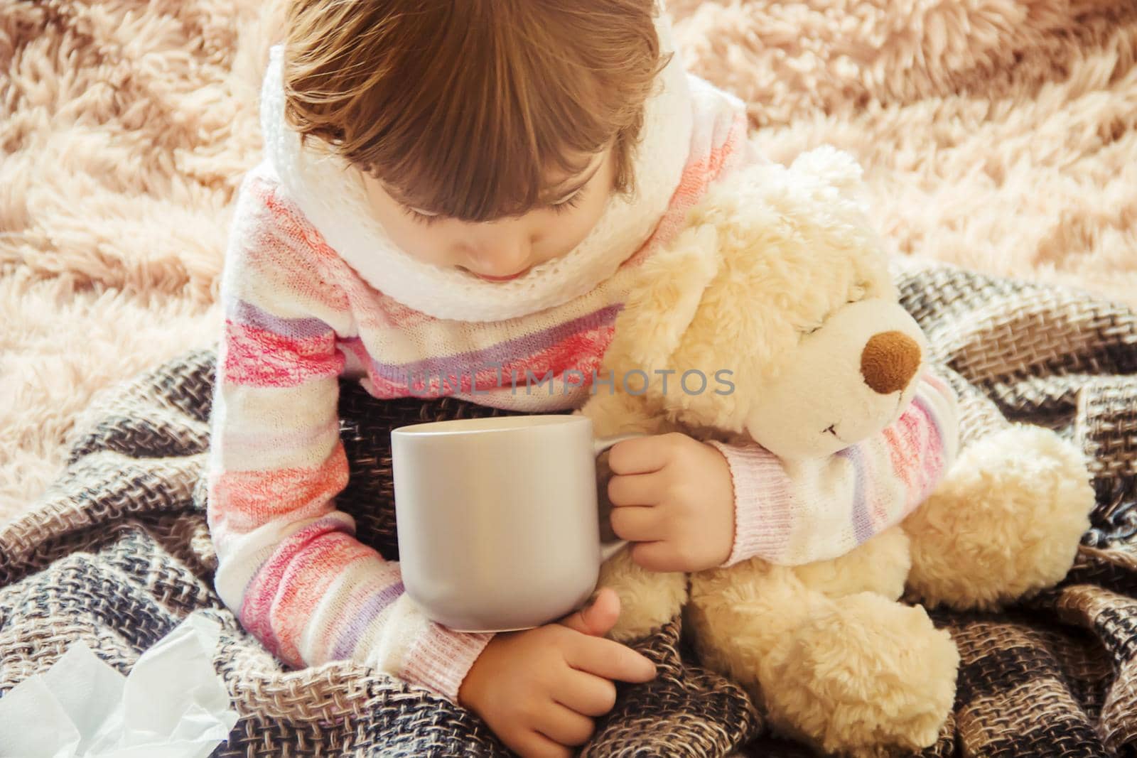 The child is sick and drinks a lot of tea. Selective focus. children.