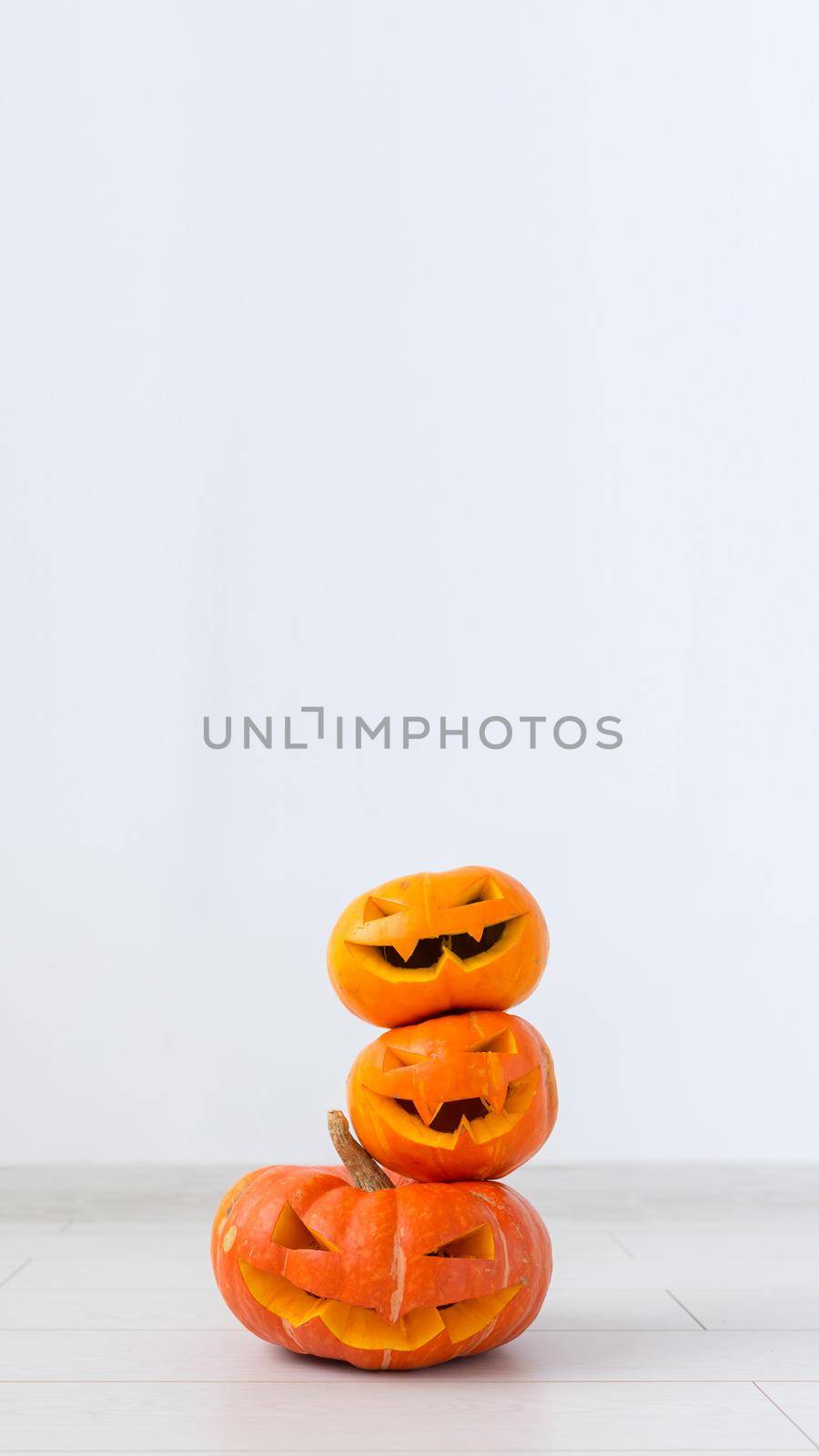 Halloween Pumpkins. Funny Jack O'Lantern on the light room.