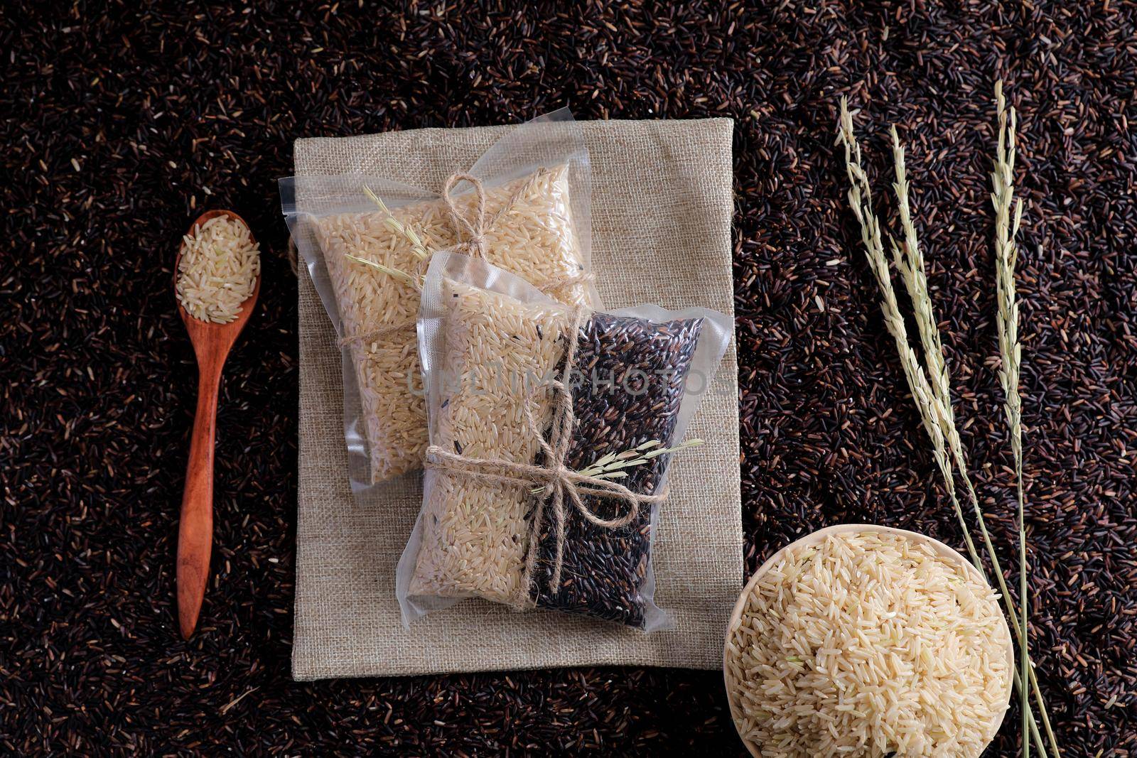 Organic raw brown rice and riceberry rice in close up by piyato