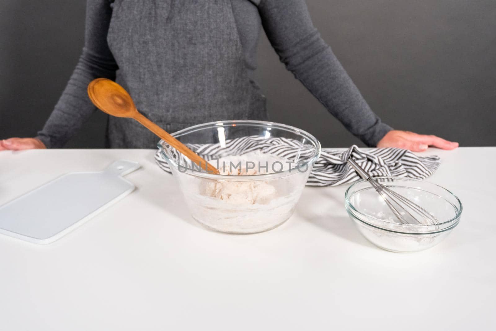 Mixing ingredients in a glass mixing bowl to make homemade flatbread.