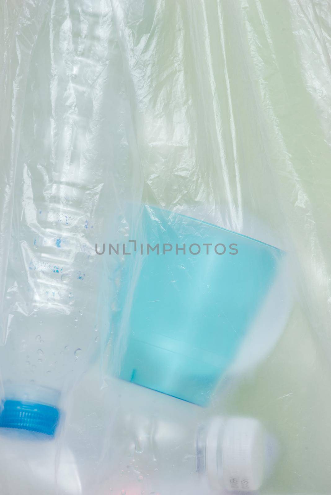 Plastic bag filled with household waste isolated on white background.