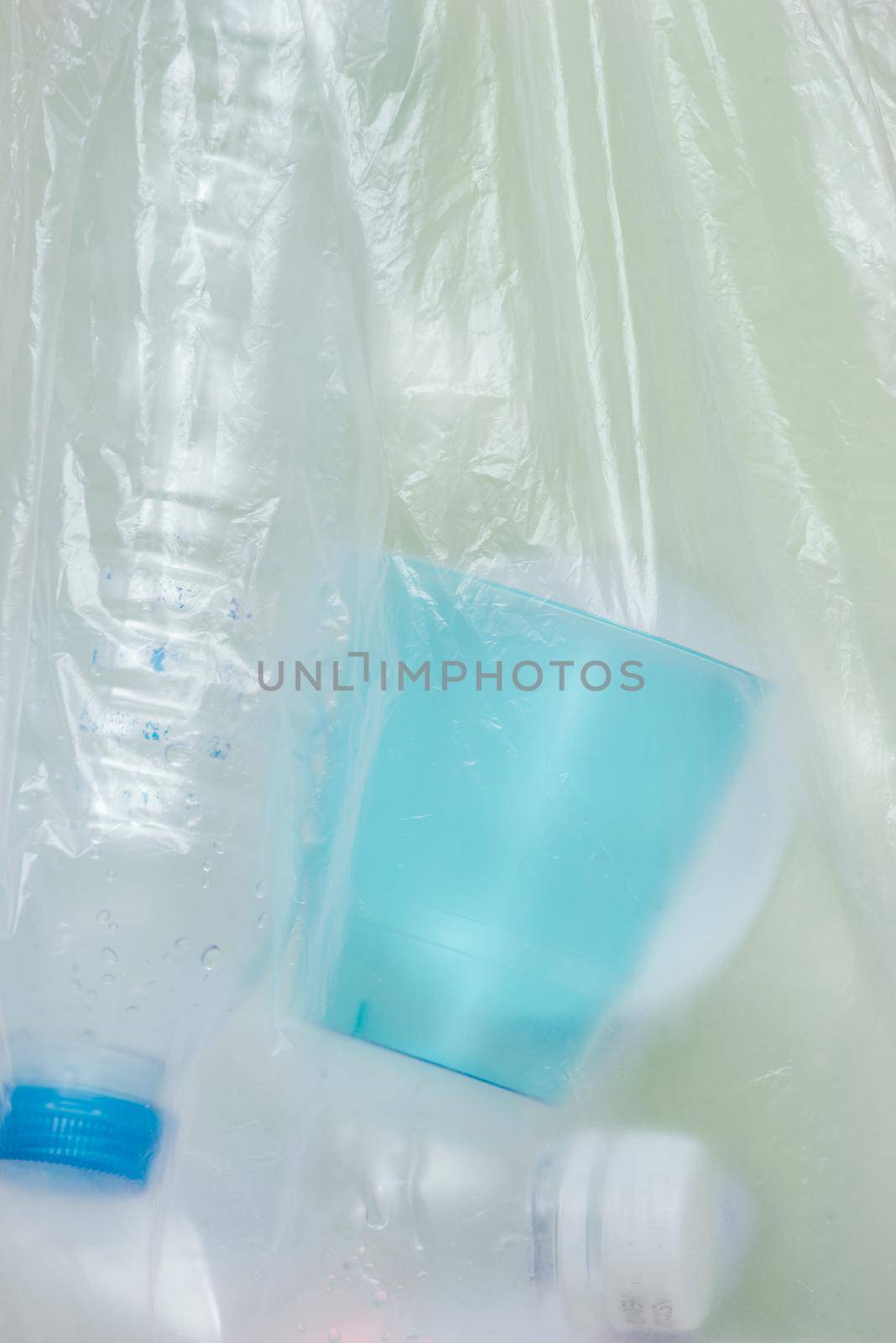 Plastic bag filled with household waste isolated on white background. by makidotvn