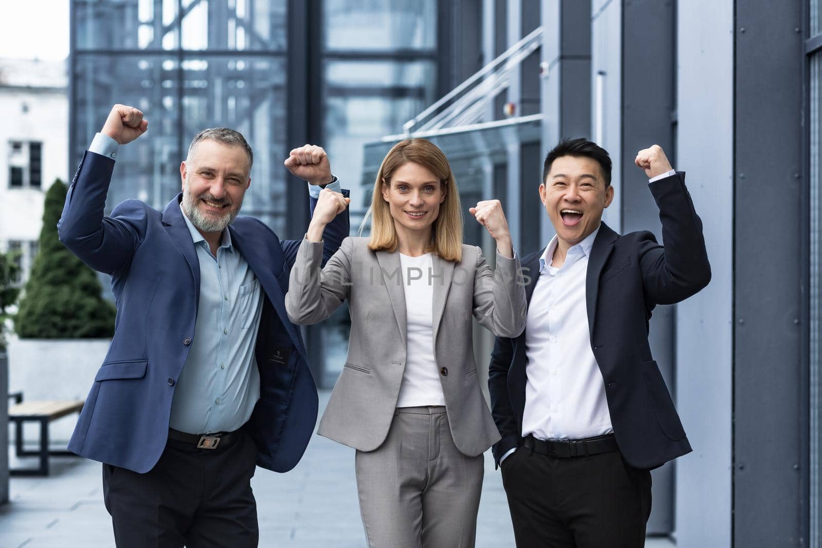 Success Happy Group business people excited rejoicing looking at camera after successful completion project, and smiling Portrait diverse team employees celebrating victory.