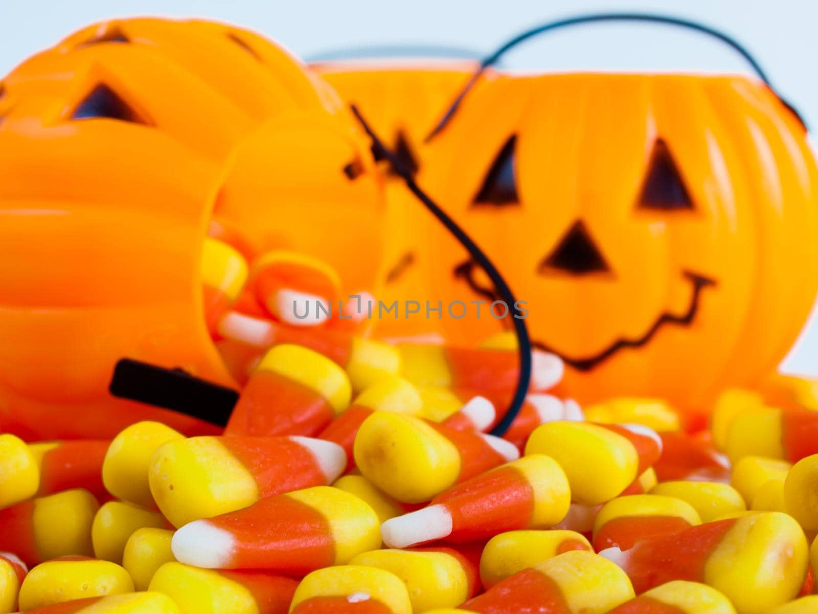 Candy corn candies falling out of Halloween treat bag.