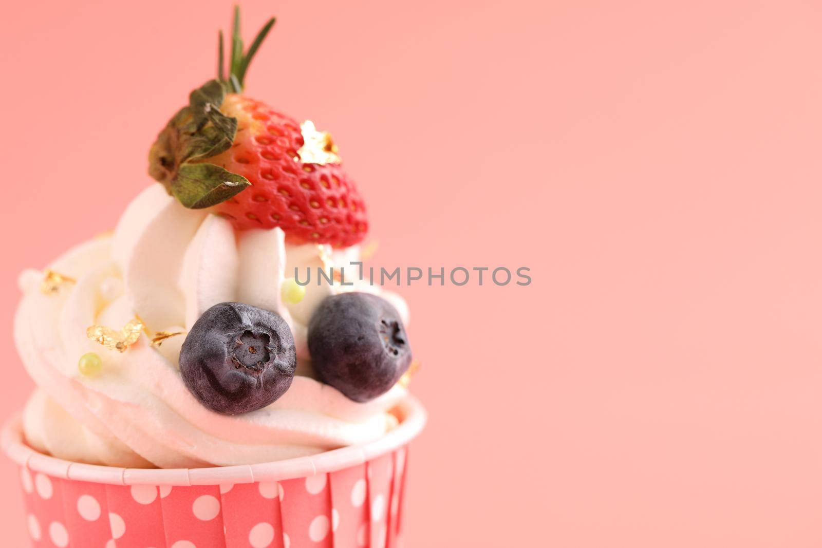 Fruits cupcake isolated in pink background by piyato