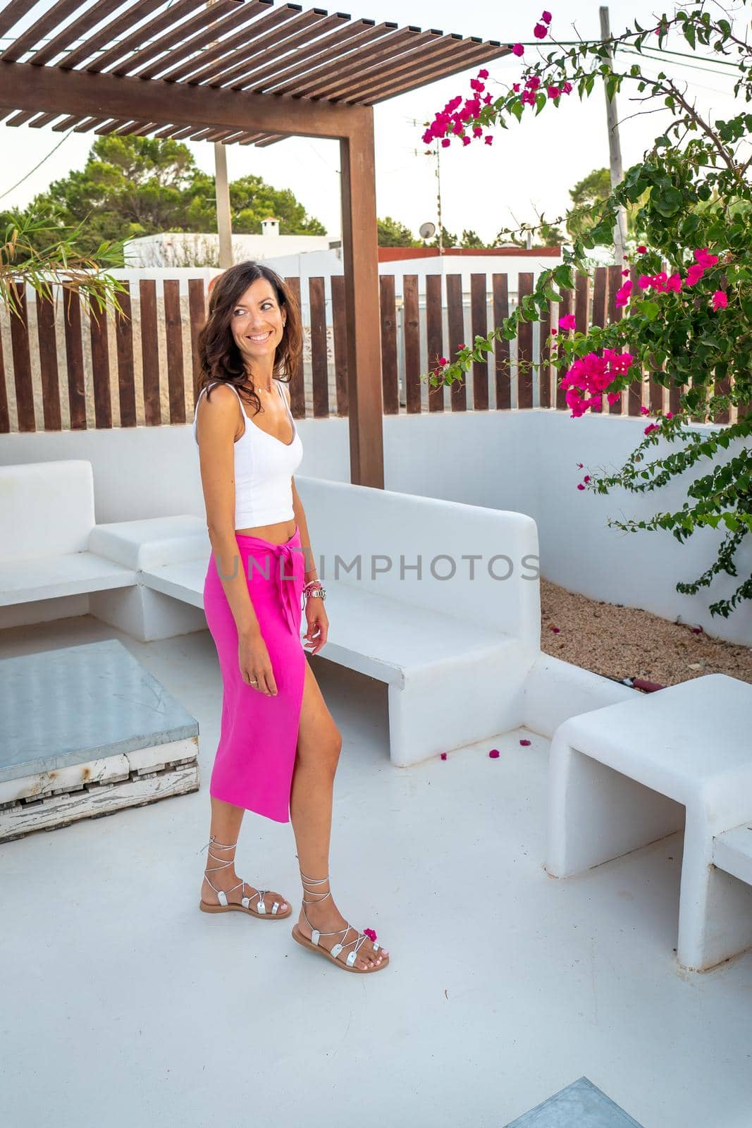 Brunette woman with pink skirt posing in a boutique hotel by LopezPastor