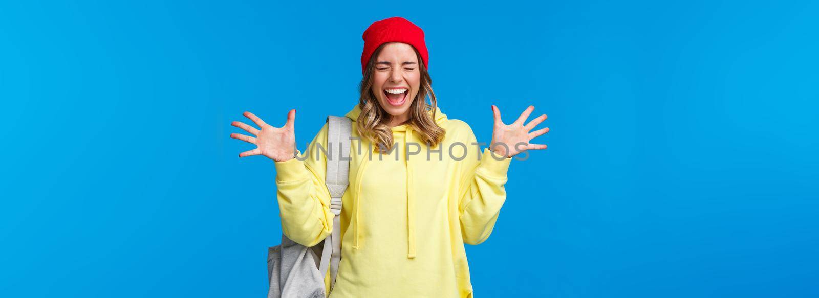 Carefree happy girl relieved finally classes are over and summer vacation starting, screaming from joy and positive emotions with closed eyes shaking hands happily, carry backpack by Benzoix