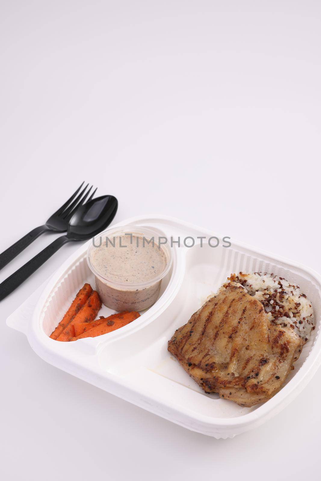 Grilled chicken with rice with delivery package isolated in white background