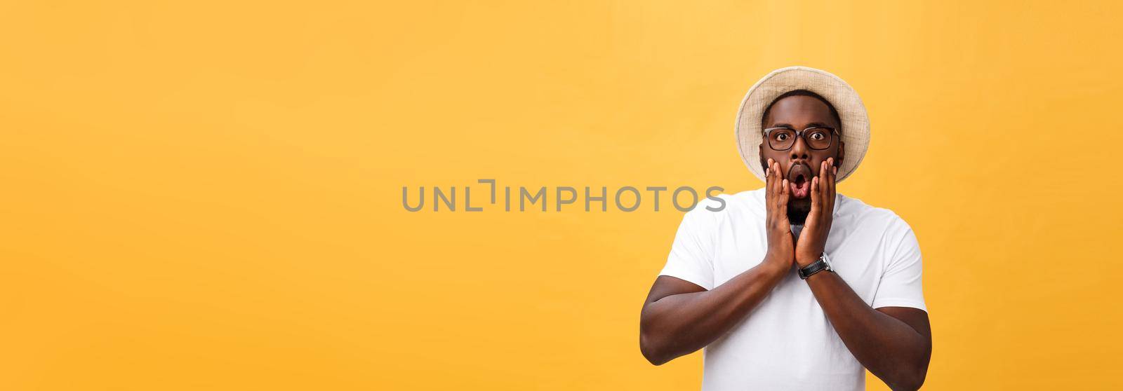 Headshot of goofy surprised bug-eyed young dark-skinned man student wearing casual white t-shirt staring at camera with shocked look