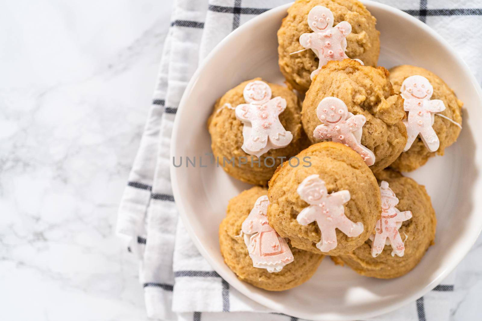 Eggnog cookies with a chocolate gingerbread man on a white plate.
