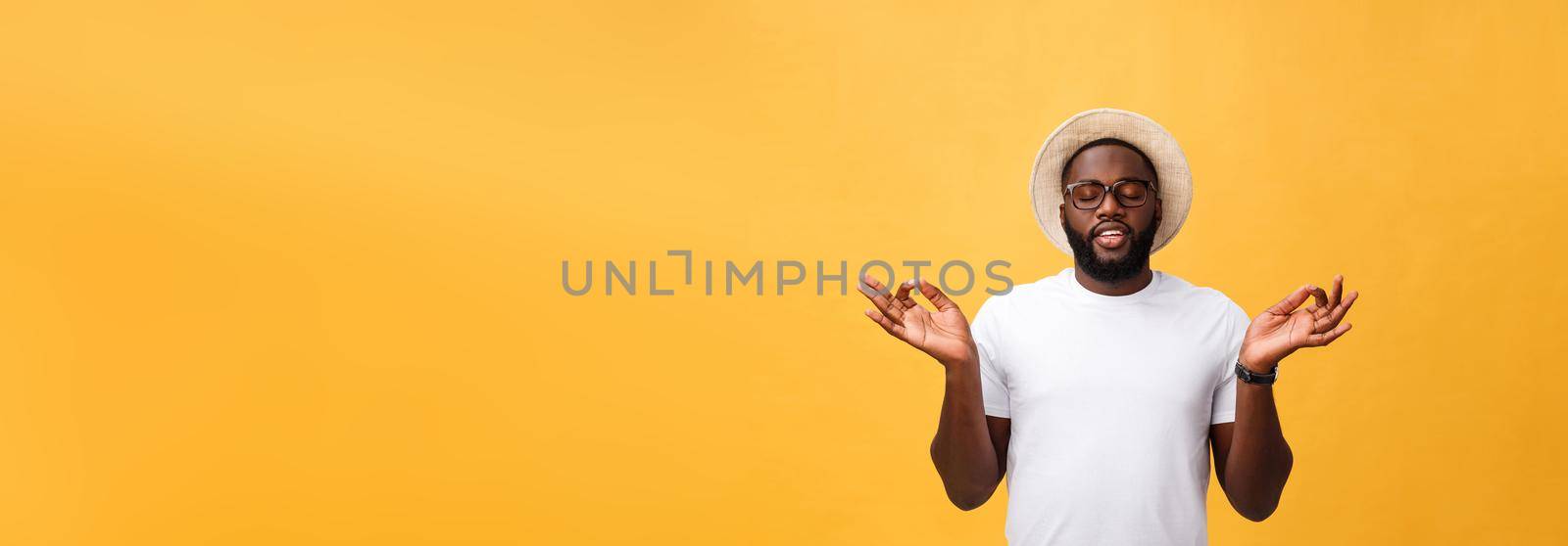 Closeup portrait of happy handsome, young man in meditation yoga mode, isolated on yellow background. Stress relief techniques concept. by Benzoix